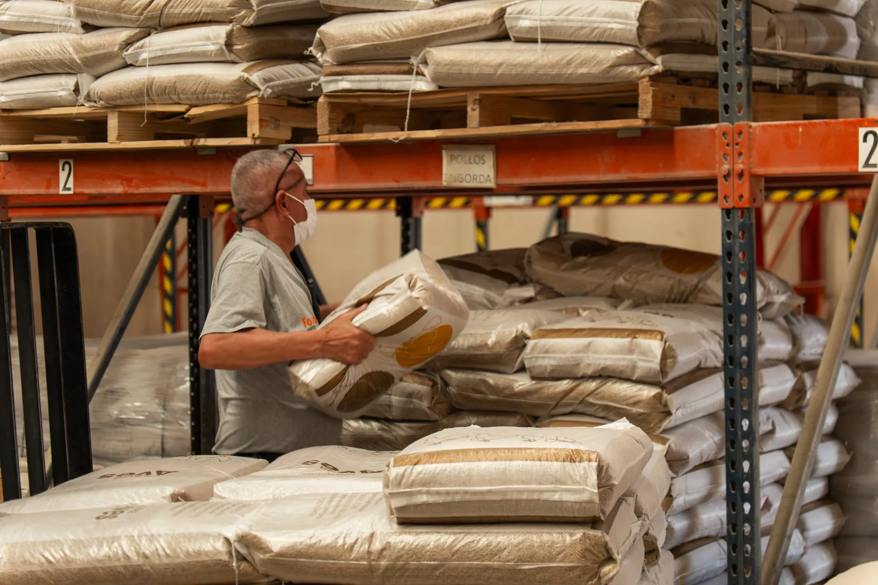 Folapsa team member stacking feed bags